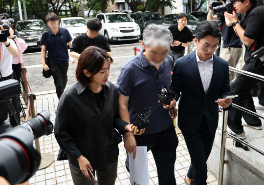 '5개 종목 하한가 사태'와 관련해 온라인 주식정보 카페 운영자 강모 씨(앞) 등 3명이 12일 오전 양천구 서울남부지법에서 열리는 영장실질심사에 출석하고 있다. 연합뉴스